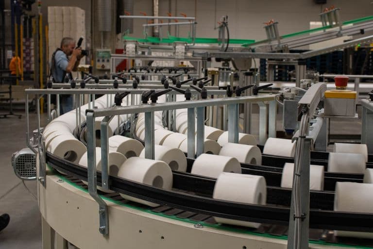 Camera-based inspection system monitoring products on a conveyor belt in a European factory